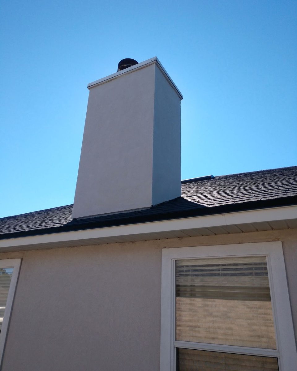The same chimney and siding after a house wash